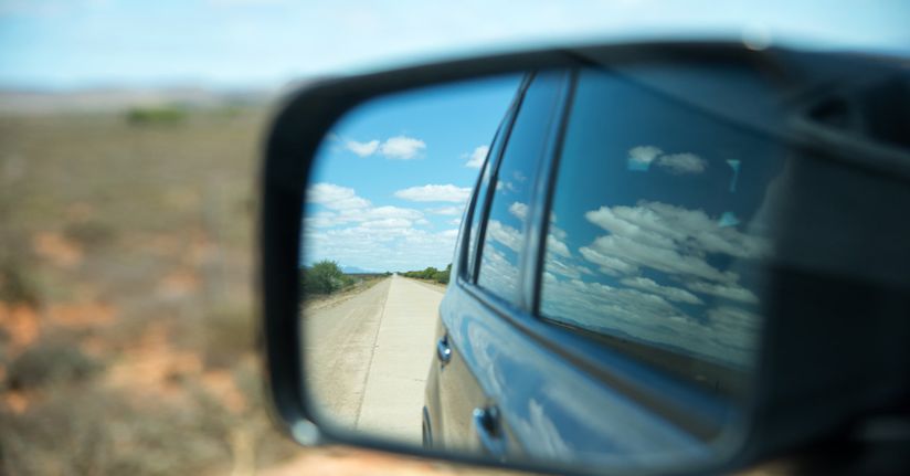 Adjust car side mirror for night driving